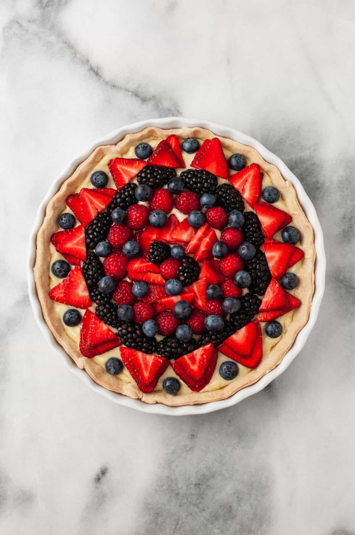 Fresh fruit tart with pie crust in pan.