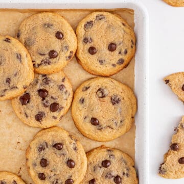 Crispy chewy chocolate chip cookies on a baking sheet.