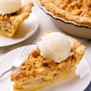 A slice of Dutch apple pie topped with ice cream.