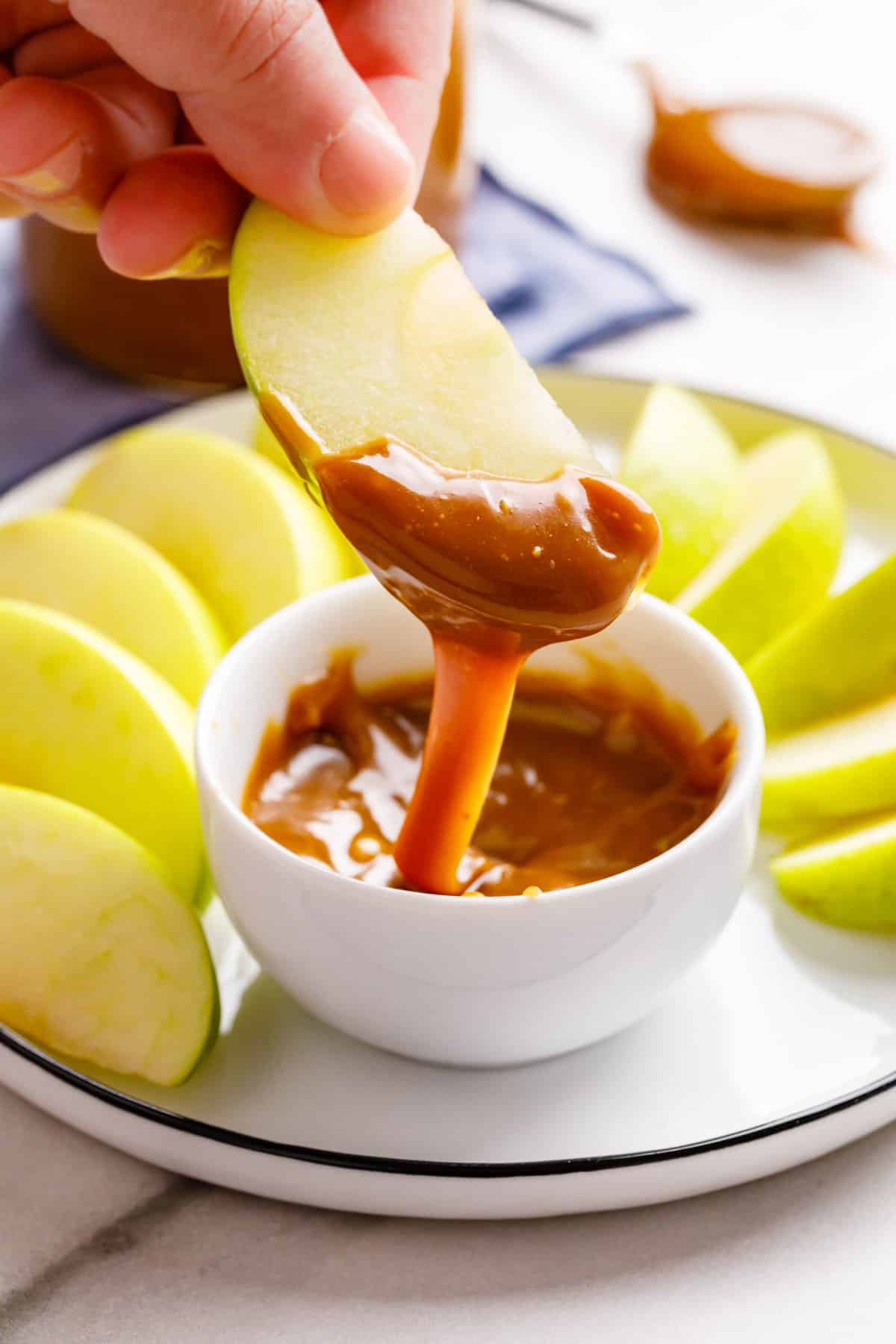 granny smith apple dipped in homemade caramel sauce