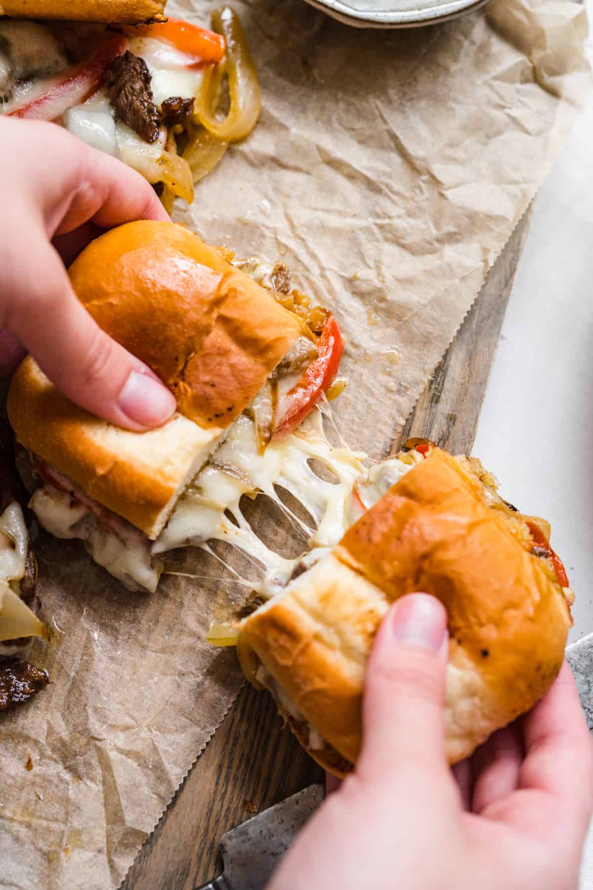 philly cheesesteak cut in half and pulled to show cheese pull