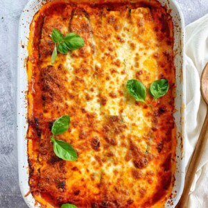 Turkey lasagna with zucchini in a white pan.