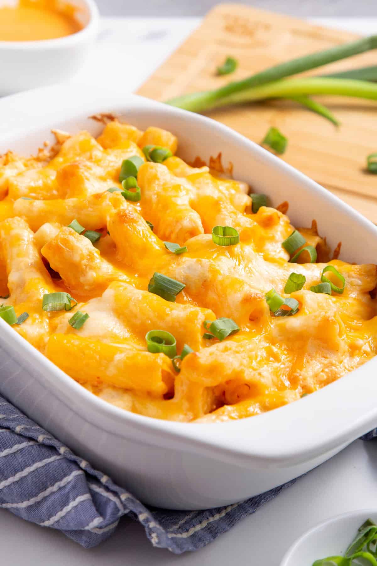 Buffalo chicken casserole served in a casserole fish topped with chopped green onions