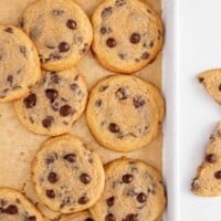 Crispy chewy chocolate chip cookies on a baking sheet.