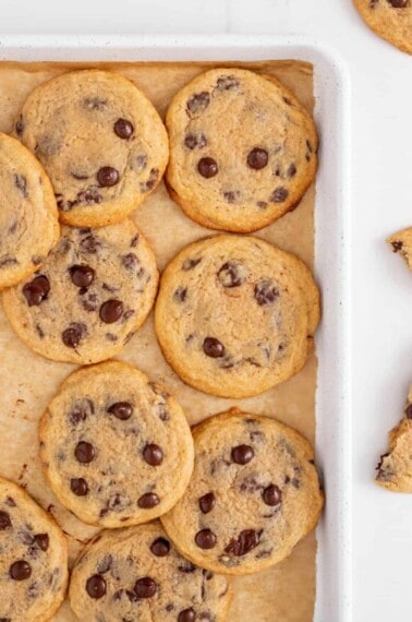 Crispy chewy chocolate chip cookies on a baking sheet.