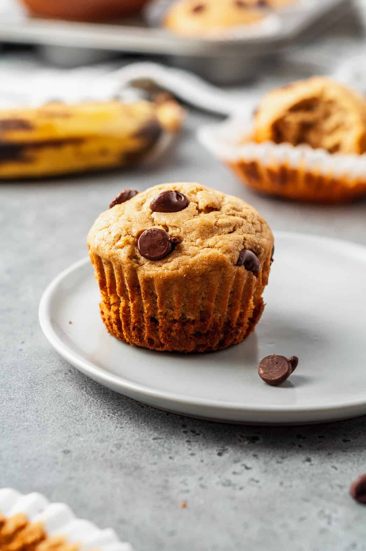 one serving of peanut butter banana muffins sitting on a grey round plate