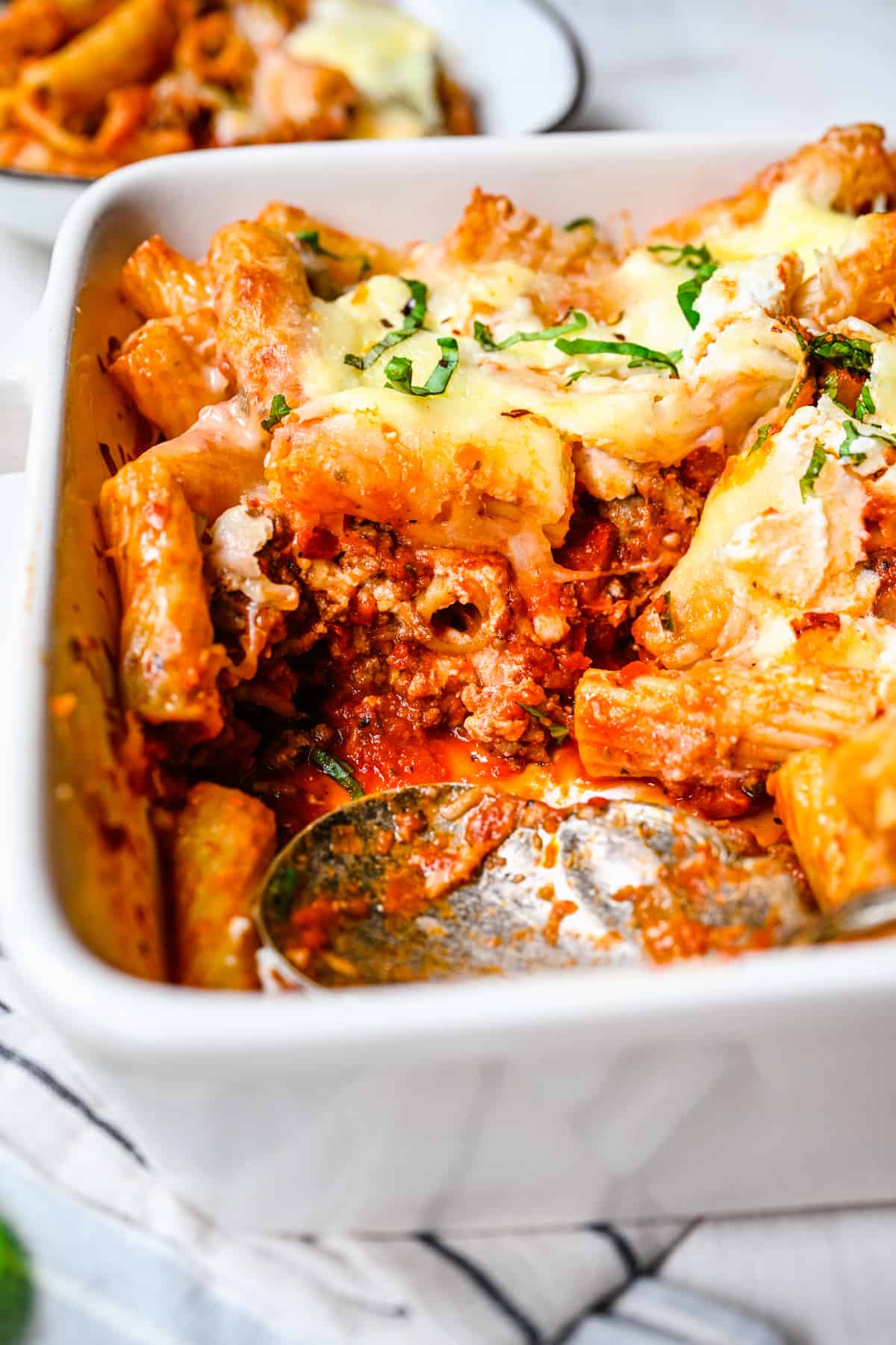 close up image of baked rigatoni served in a casserole dish