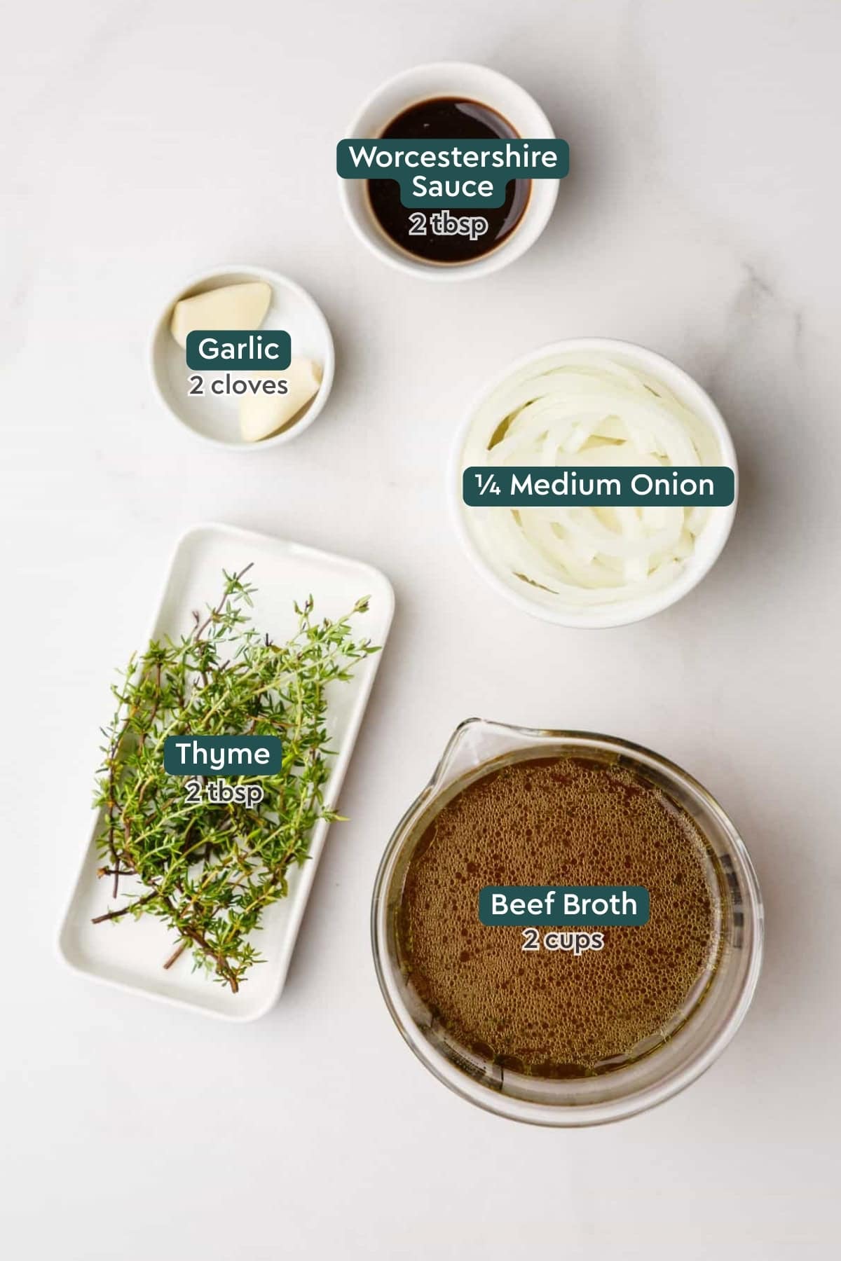 Ingredients for au just, including garlic, onion, thyme, broth, and Worcestershire.