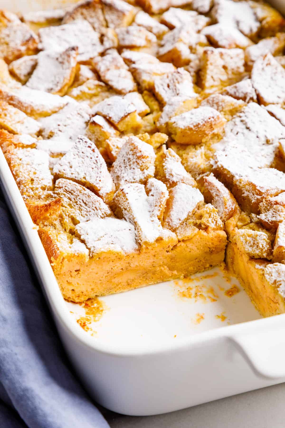 close up of the cross section of pumpkin french toast casserole served in a large casserole dish