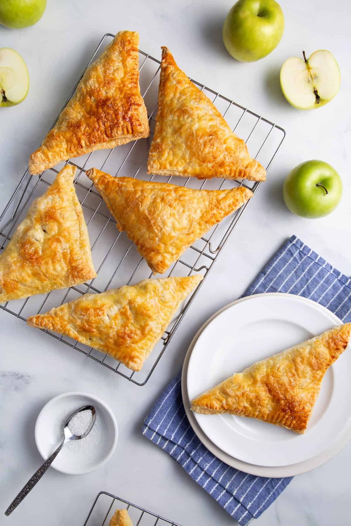 top down image of apple turnovers on a wire cooling rack