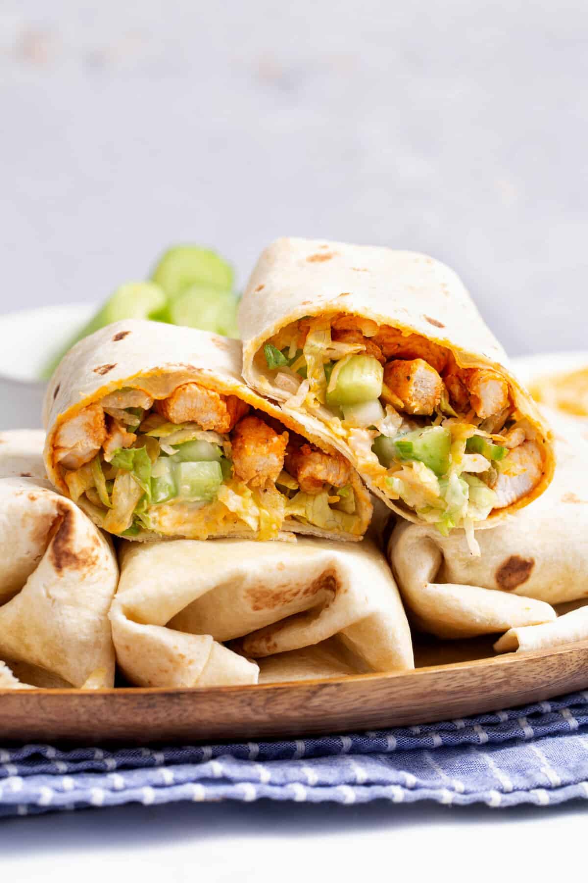 buffalo chicken wrap cut in half and stacked on other wraps