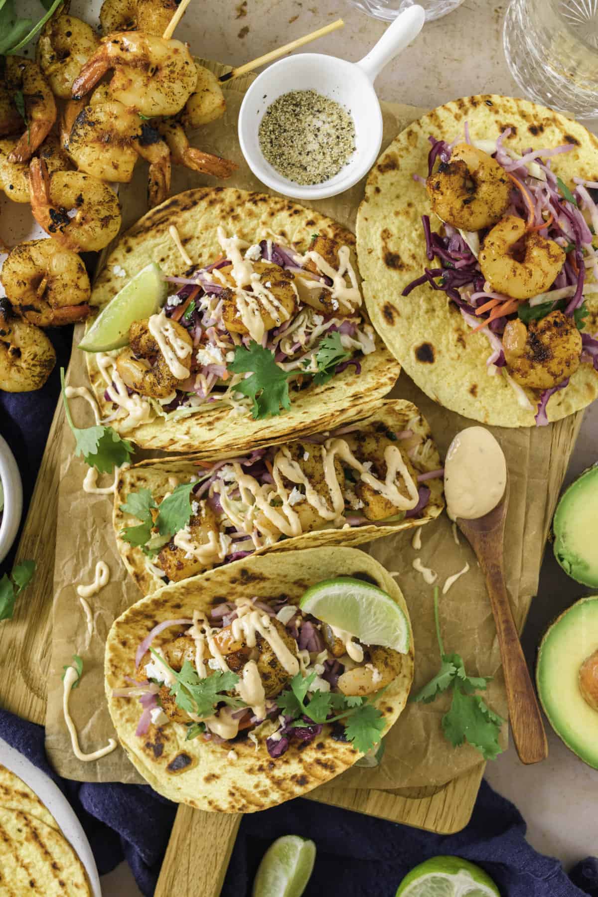 top down image of grilled shrimp tacos served on a wooden board