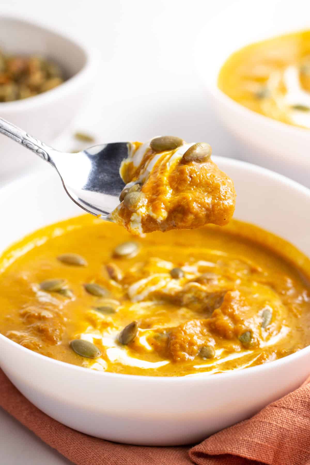 close up of a spoonful of pumpkin soup