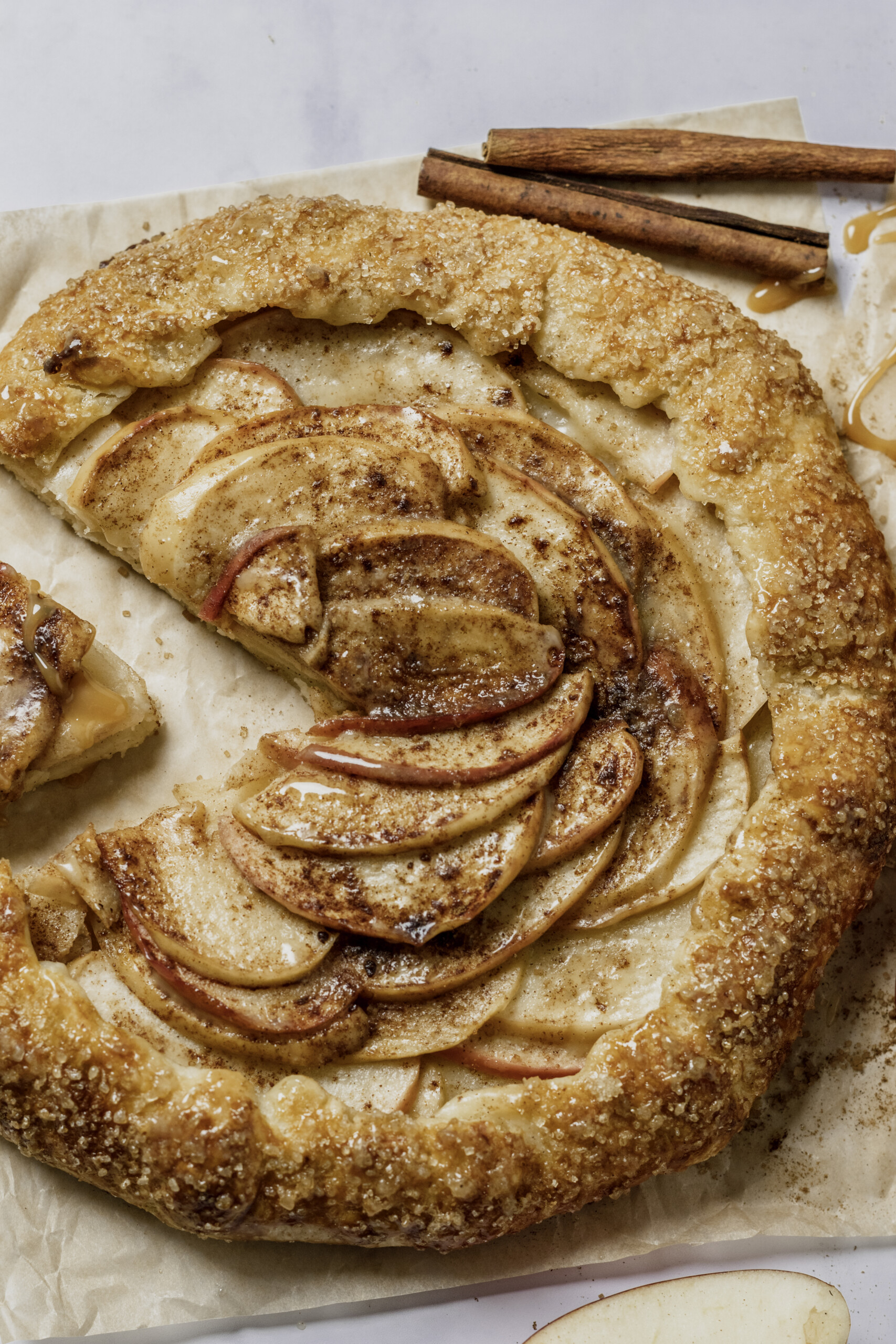 top down image of apple galette with a slice cut.