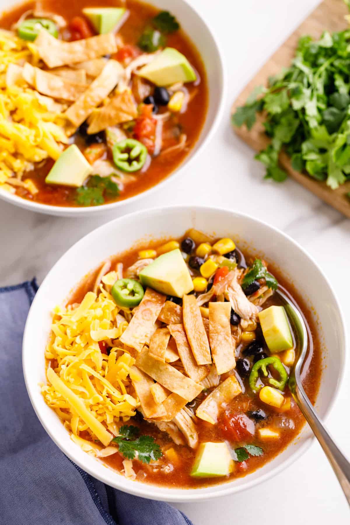 top down image of two bowls of chicken tortilla soup