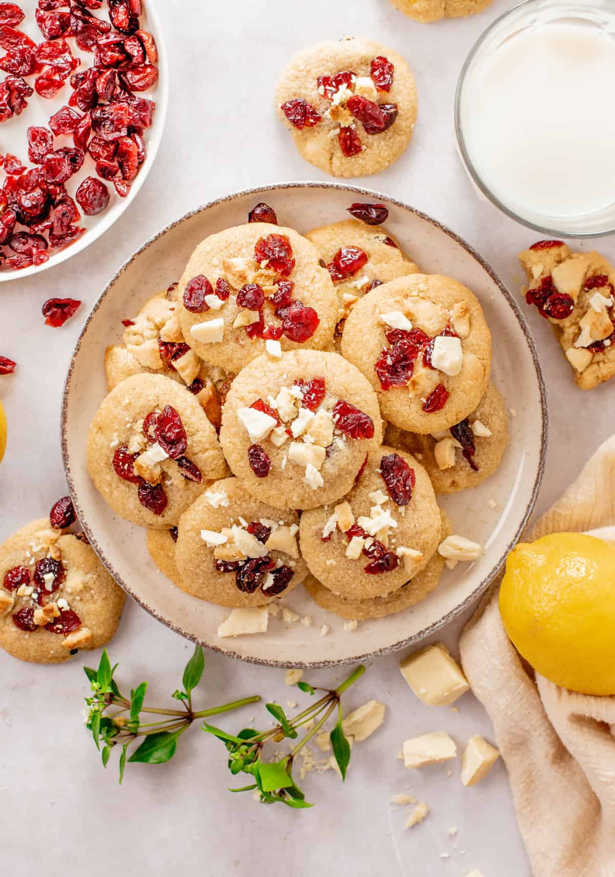top down image of cranberry white chocolate chip cookies stacked and served on a plate