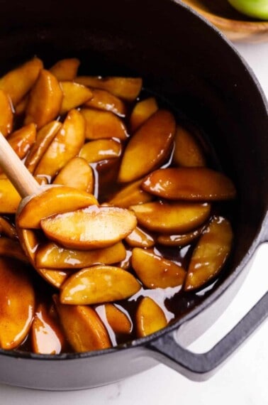 Overhead image of apple pie filling being stirred.