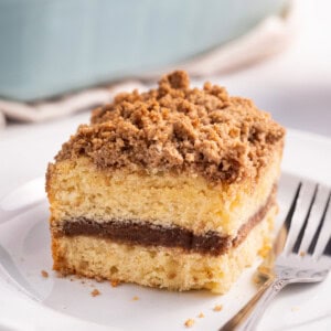 A slice of homemade coffee cake on a plate with a fork.