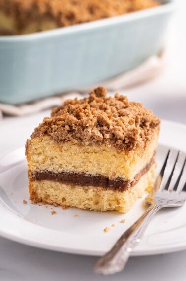 A slice of homemade coffee cake on a plate with a fork.
