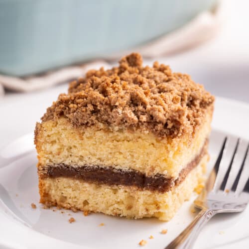 A slice of homemade coffee cake on a plate with a fork.