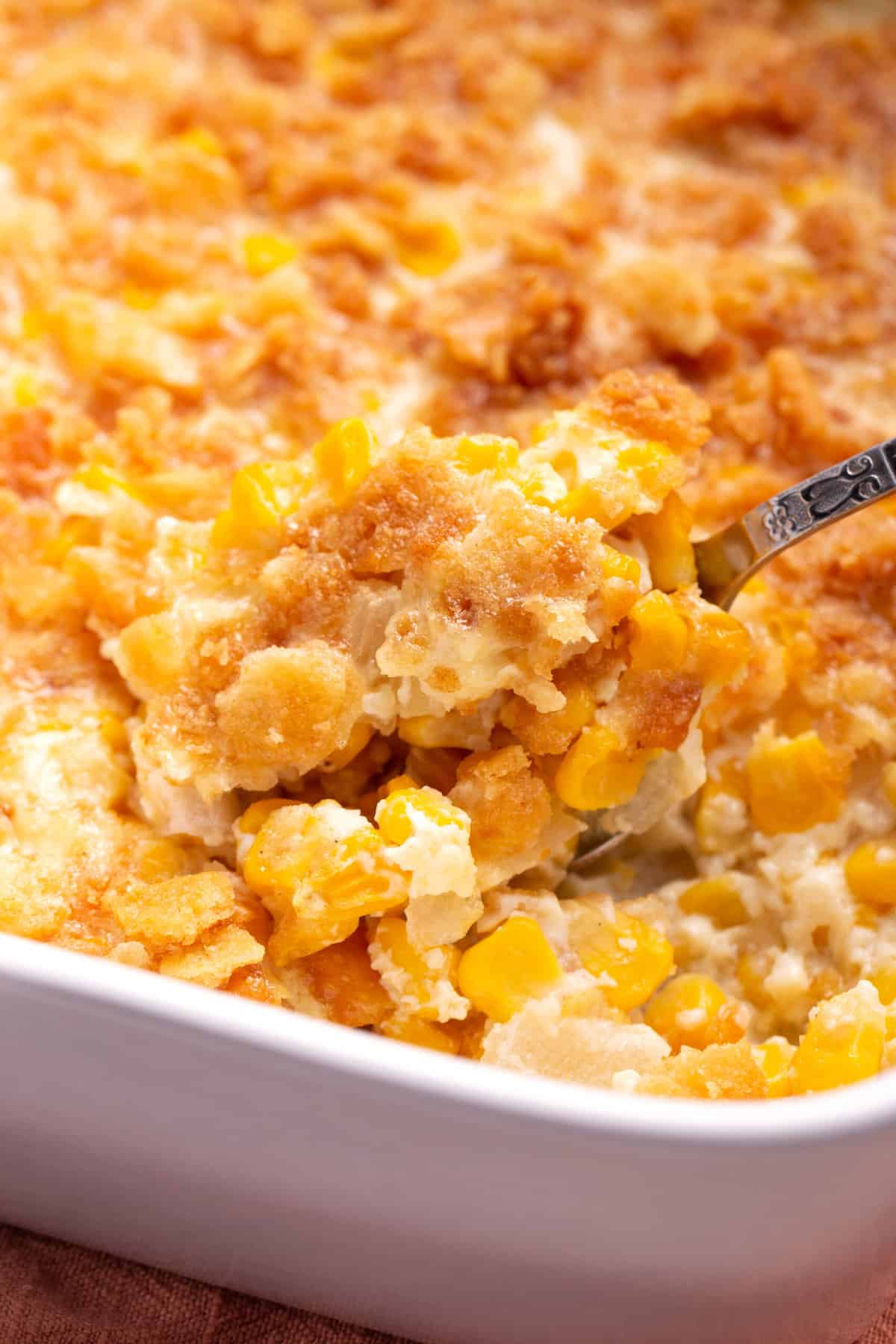 close up image of scalloped corn served in a casserole dish