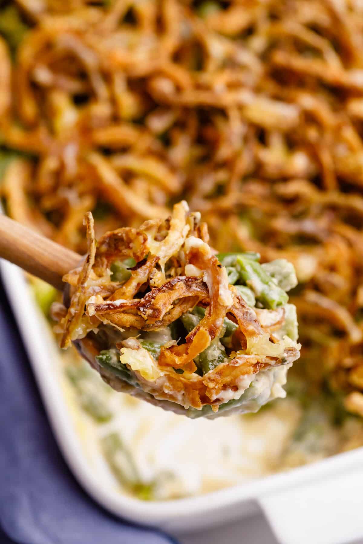 wooden spoonful of mushroom and onion green bean casserole