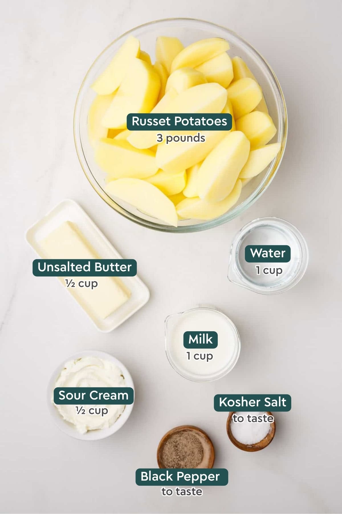 Instant pot mashed potato ingredients, including potatoes, butter, water, milk, sour cream, salt, and pepper.