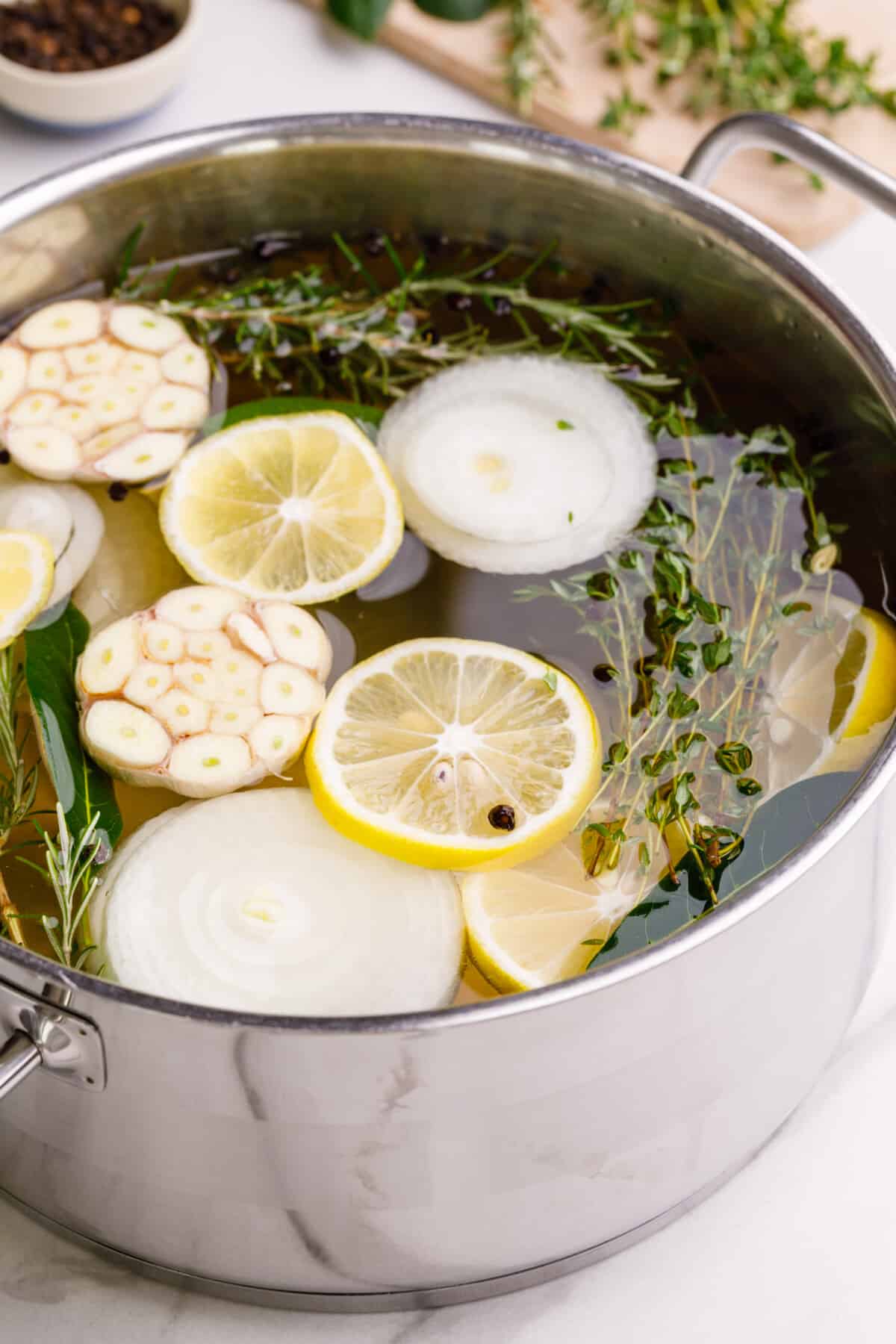A turkey brining in a pot of liquid.