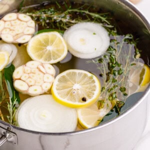 A turkey brining in a pot of liquid.