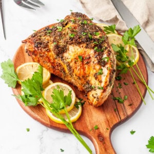 Air fryer turkey breast on a wooden cutting board.