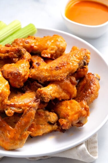 A plate of baked buffalo chicken wings.