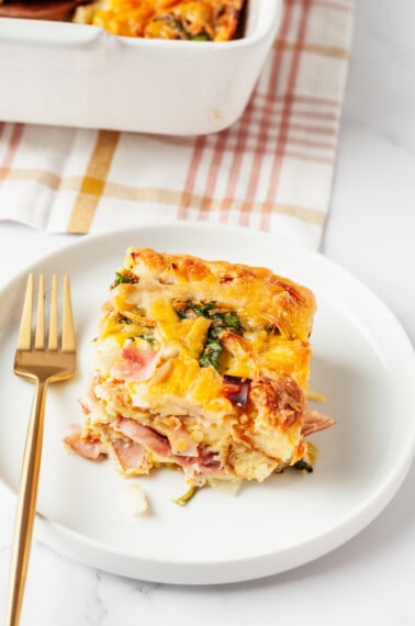 A serving of breakfast croissant casserole on a plate.