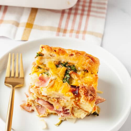 A serving of breakfast croissant casserole on a plate.