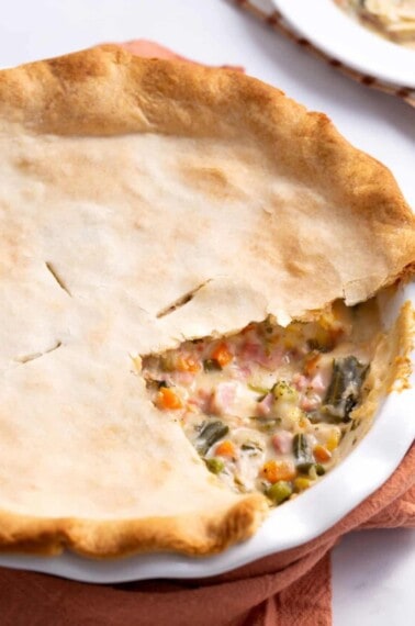 How ham pie with a slice missing, exposing the center.