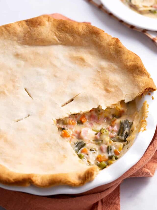 How ham pie with a slice missing, exposing the center.