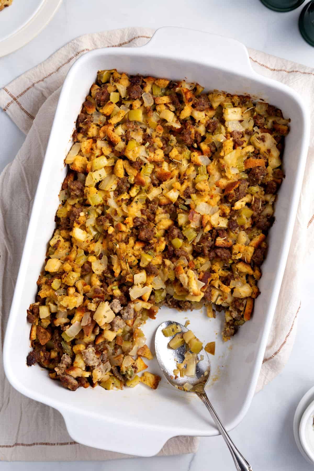 top down image of sausage and apple stuffing baked in a casserole dish