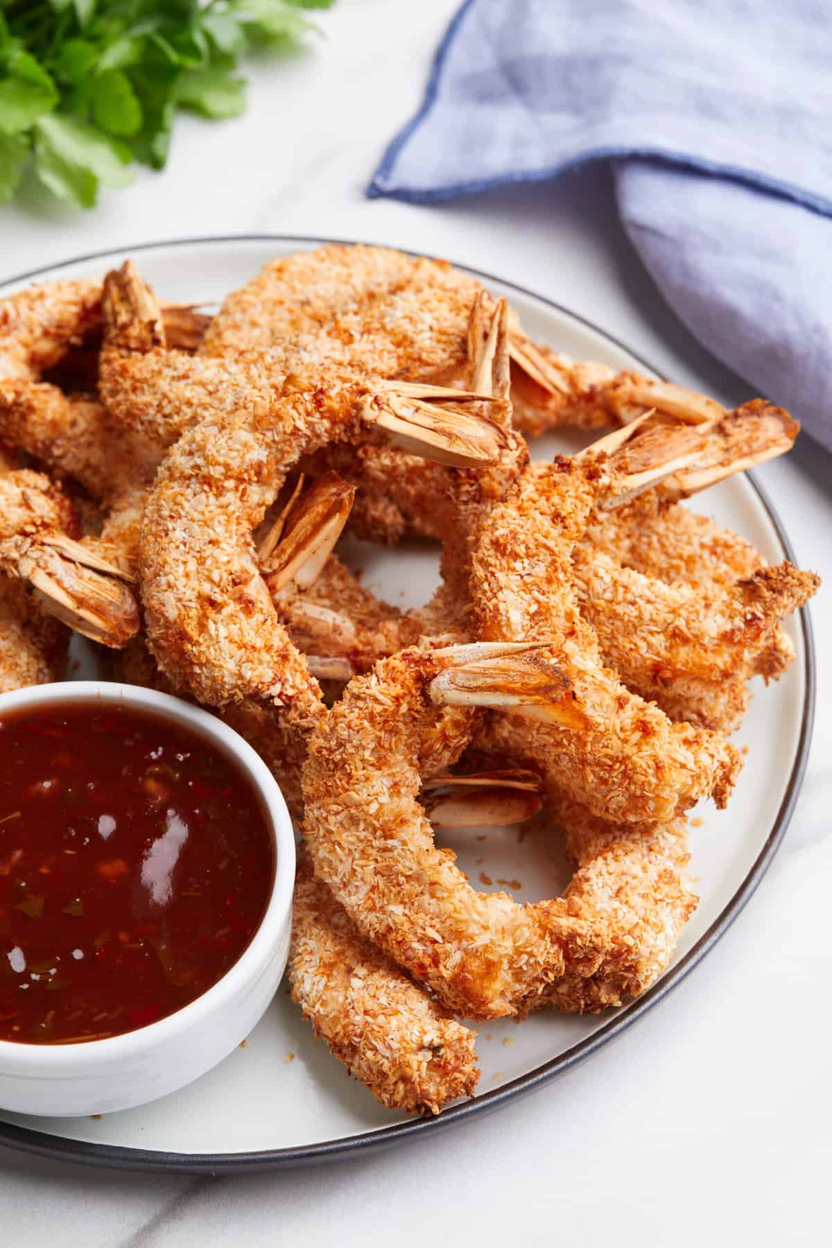 plate of air fryer coconut shrimp served with a side of sweet chili sauce