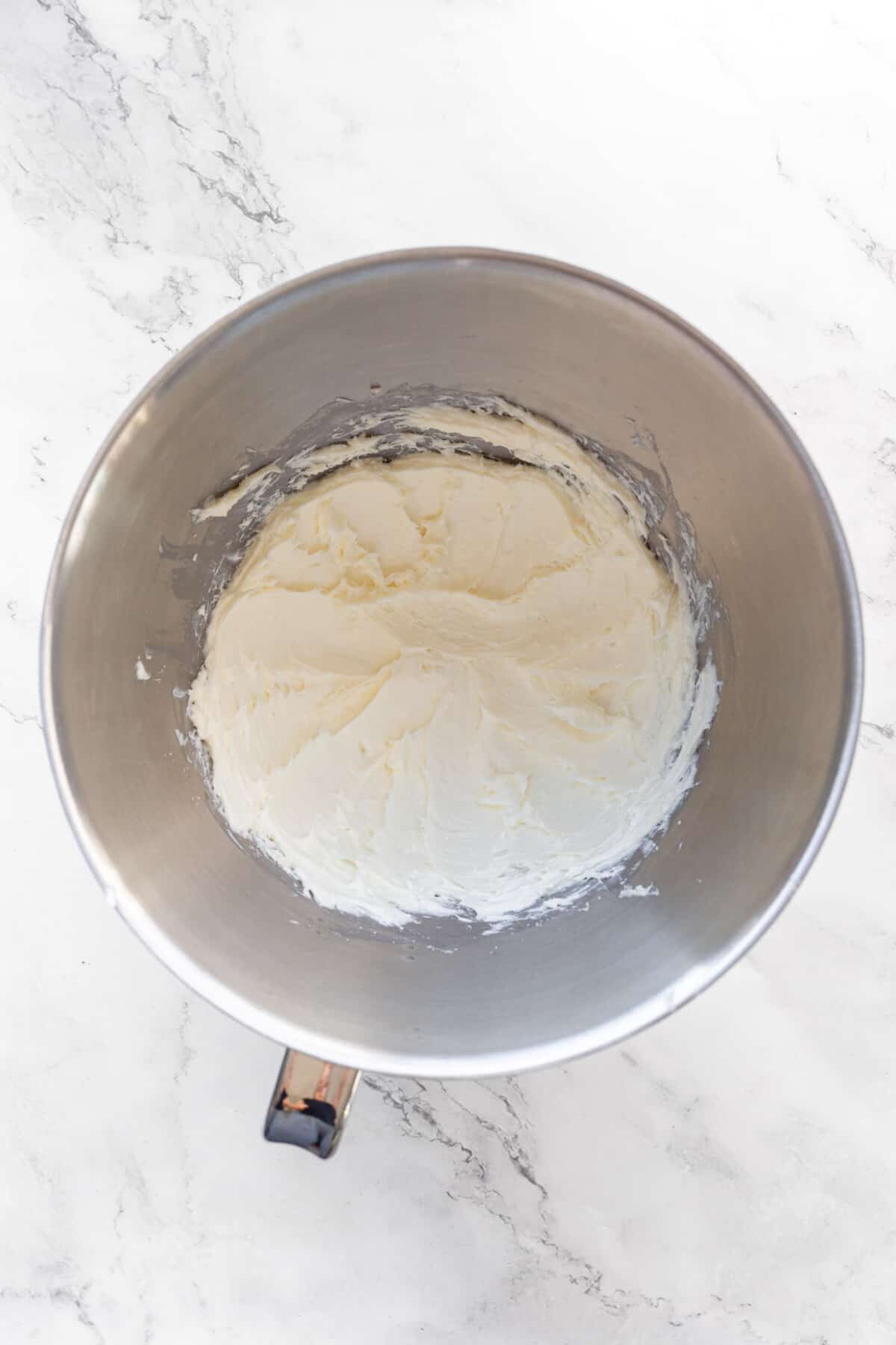 Cream cheese beaten in mixing bowl.