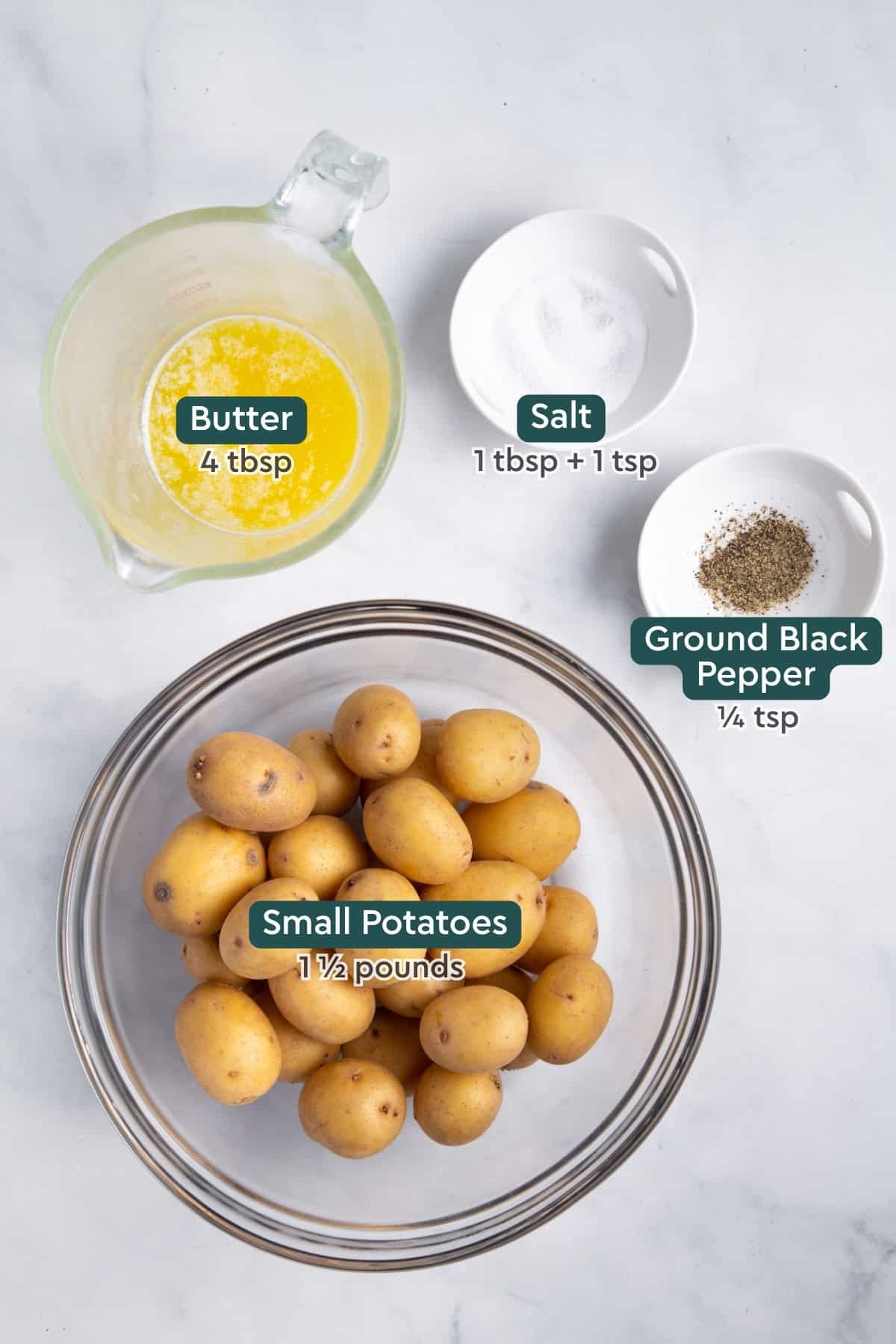 Ingredients for crispy smashed potatoes, including butter, baby potatoes, salt, and pepper.