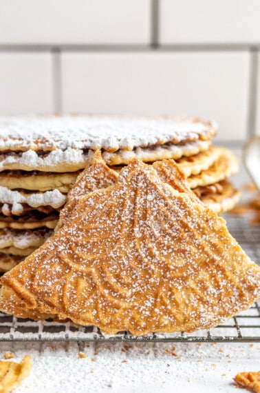 Pizzelle cookies dusted with powdered sugar.