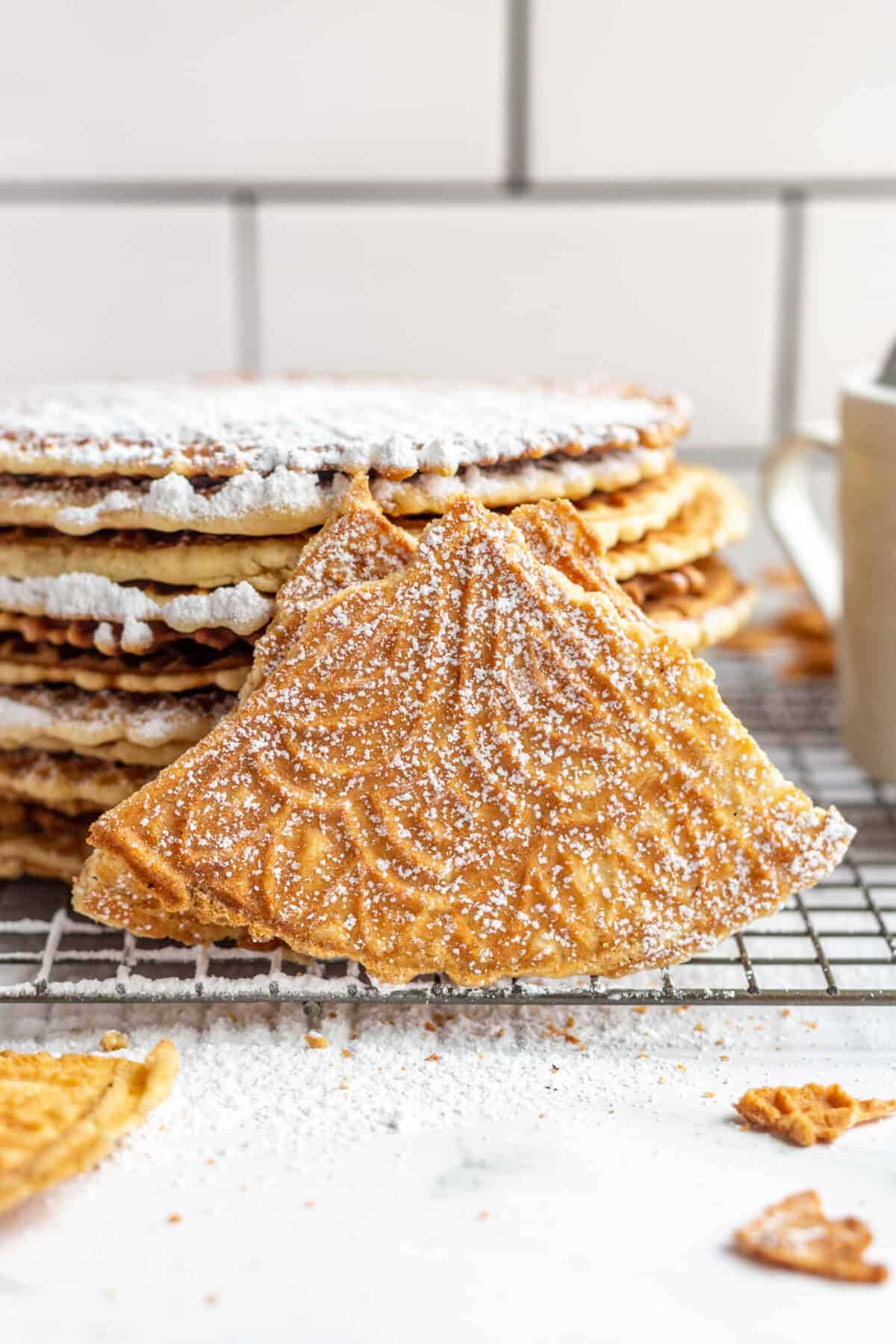 Pizzelles dusted with powdered sugar.