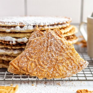Pizzelles dusted with powdered sugar.