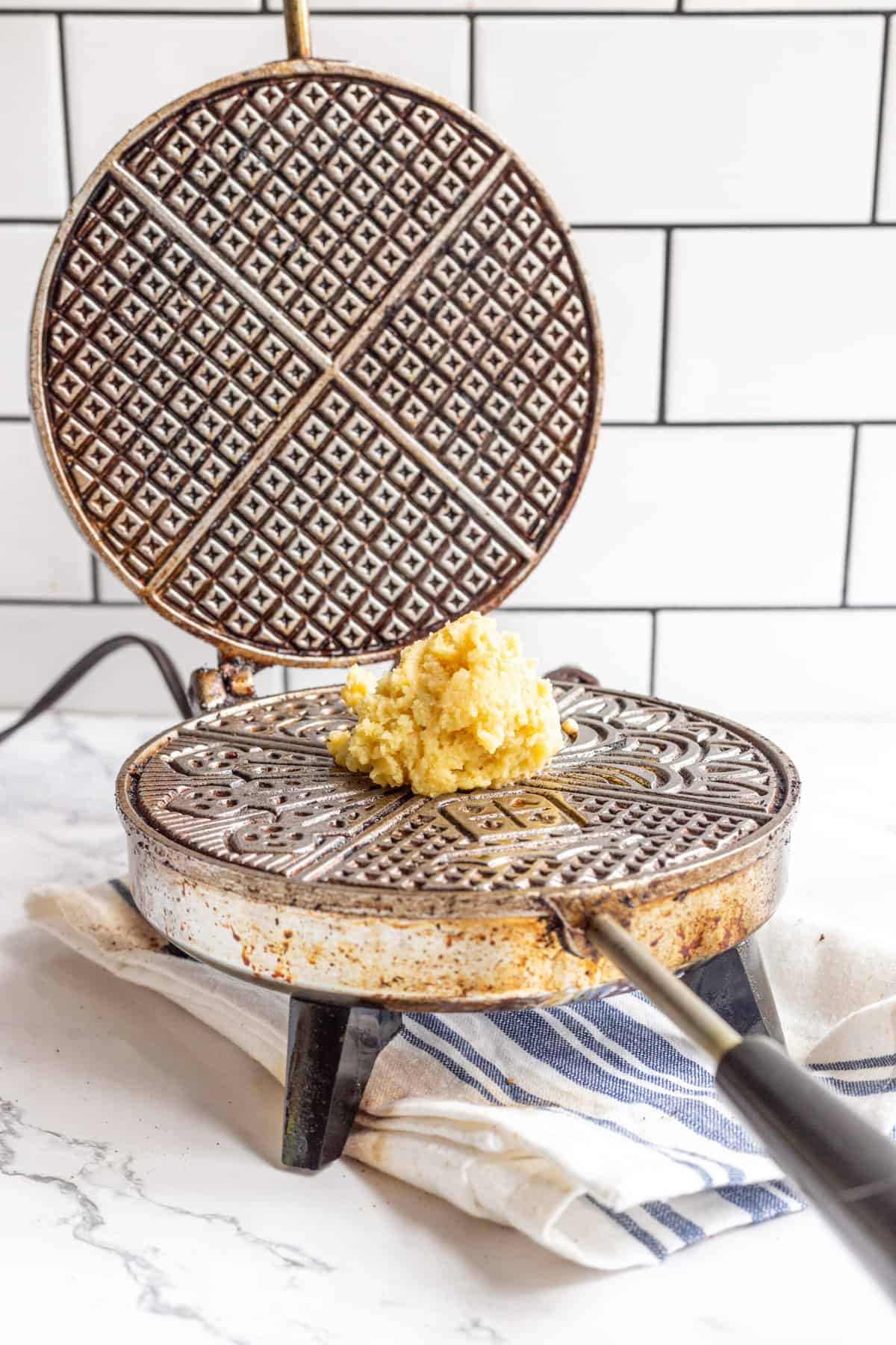Pizzelle cookie batter on a pizzelle iron. 