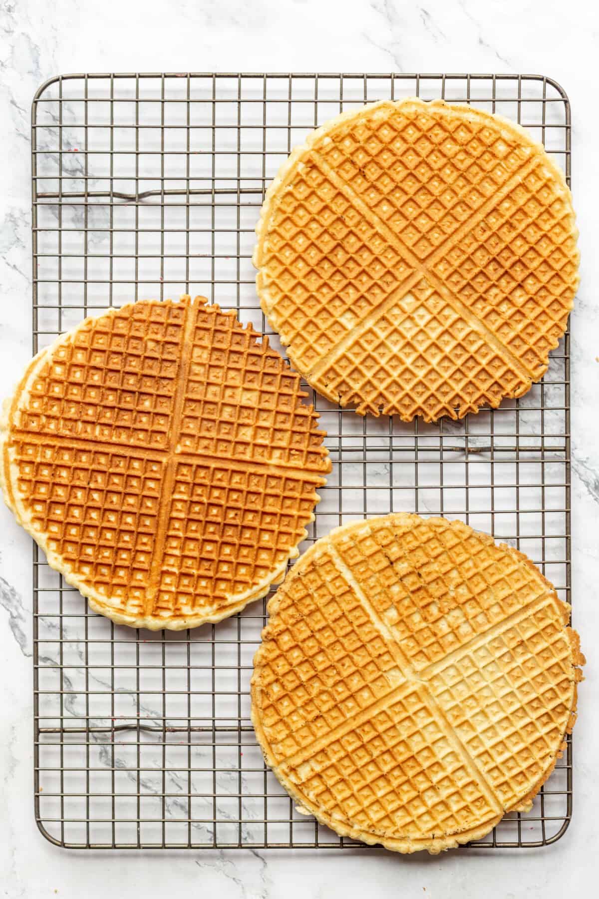 Pizzelle cookies on a wire rack. 