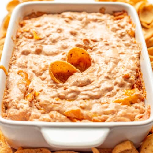 Refried bean dip with chips sticking out.