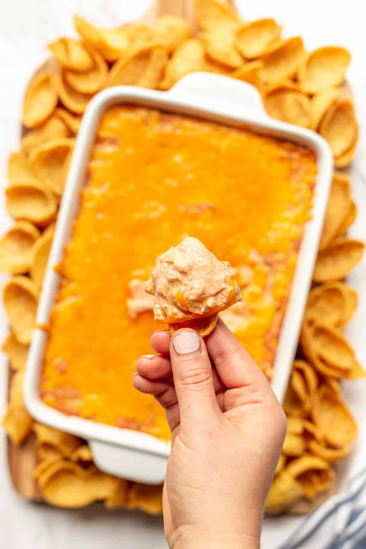 frito chip with cheesy, creamy refried bean dip