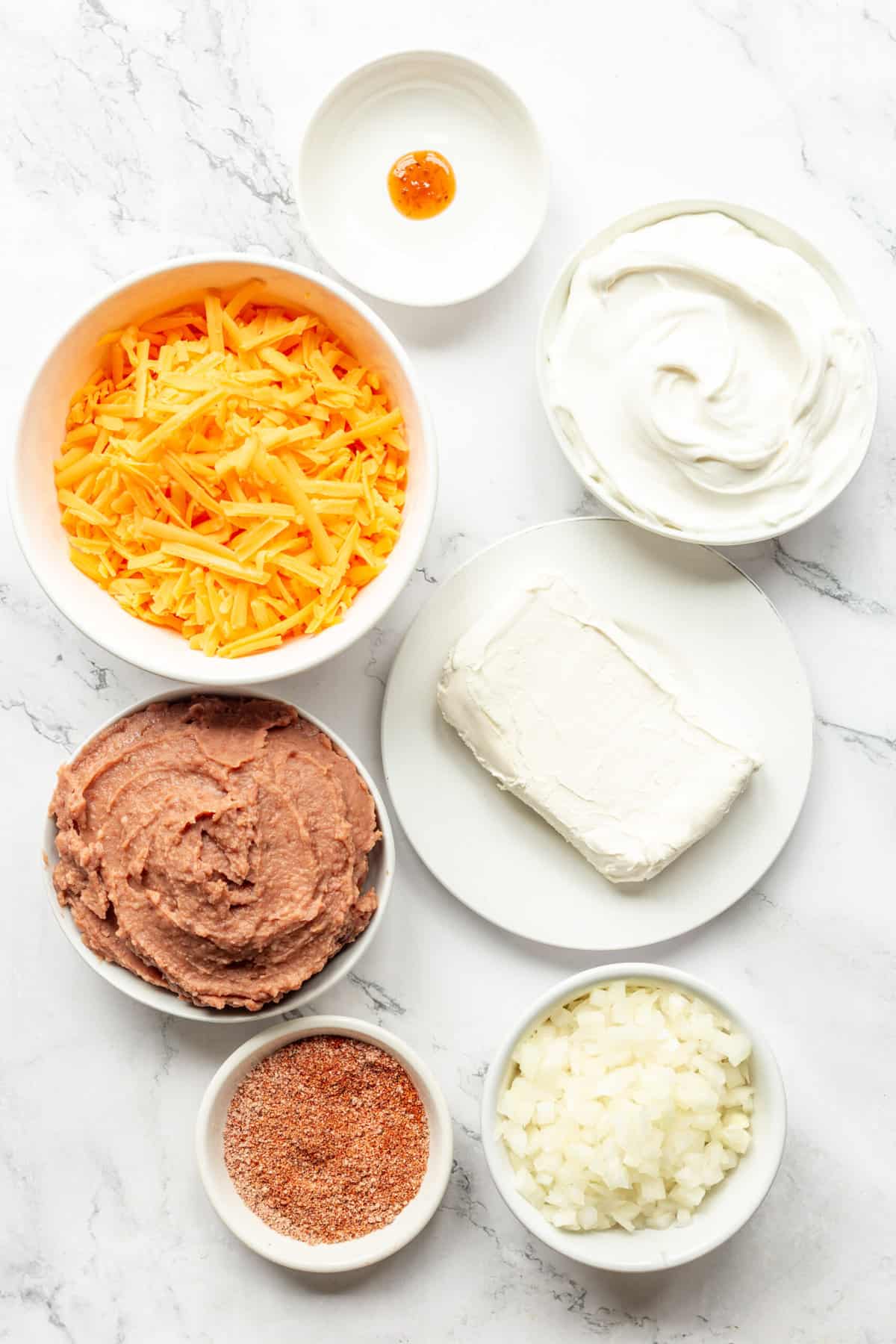 ingredients to make creamy and cheesy refried bean dip.