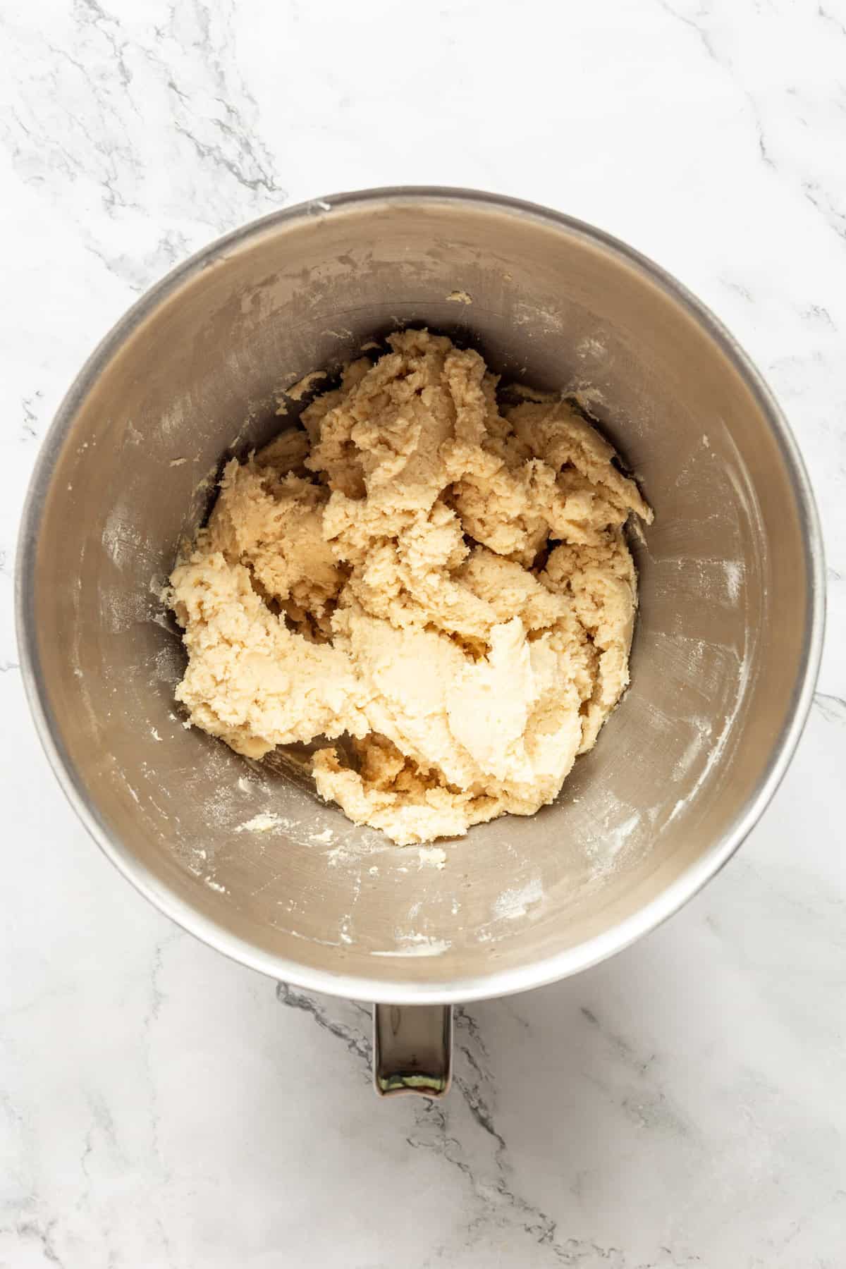Spritz Cookie dough batter in a stainless steel mixing bowl