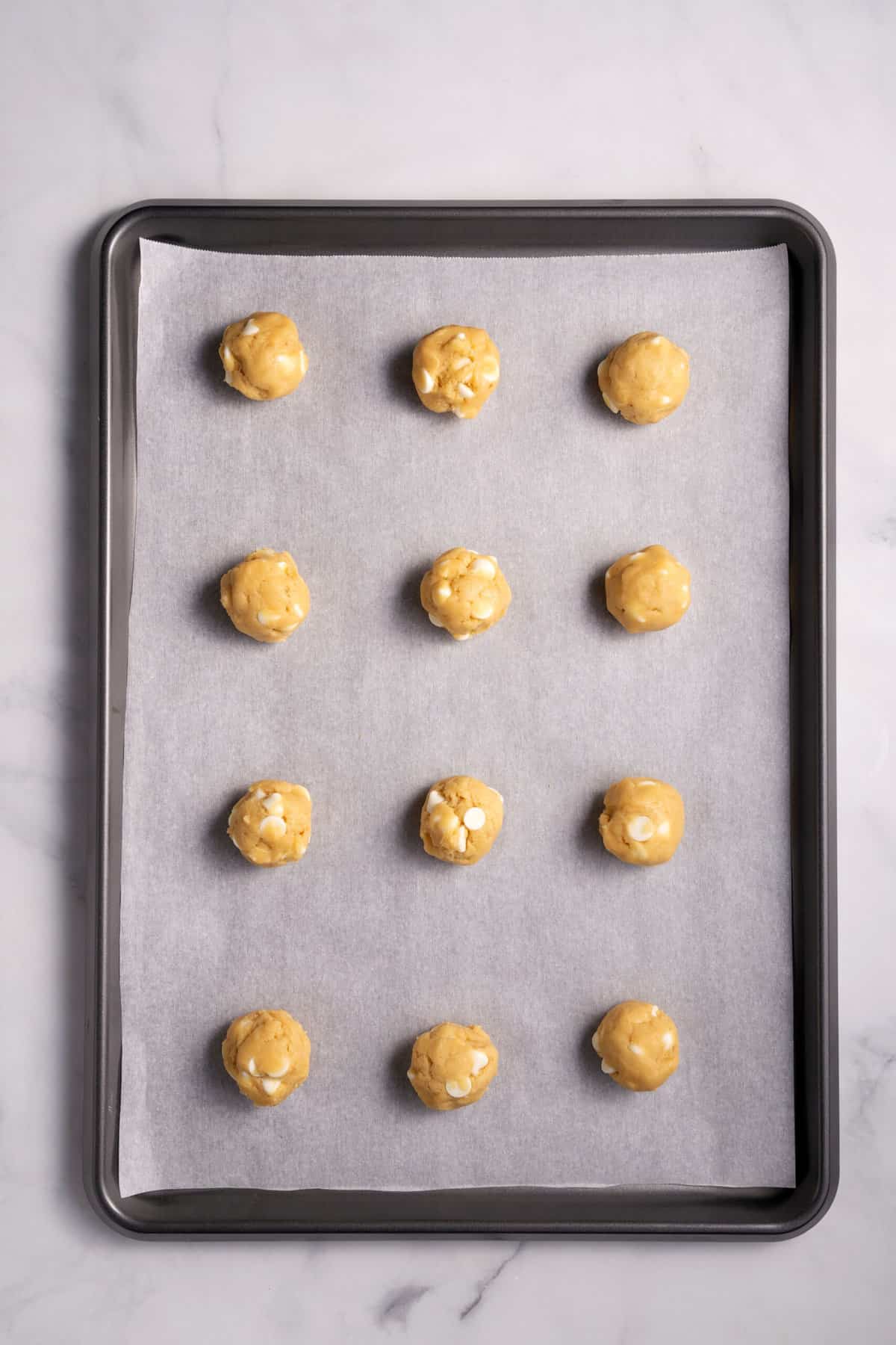 Unbaked banana pudding cookies on a baking sheet. 