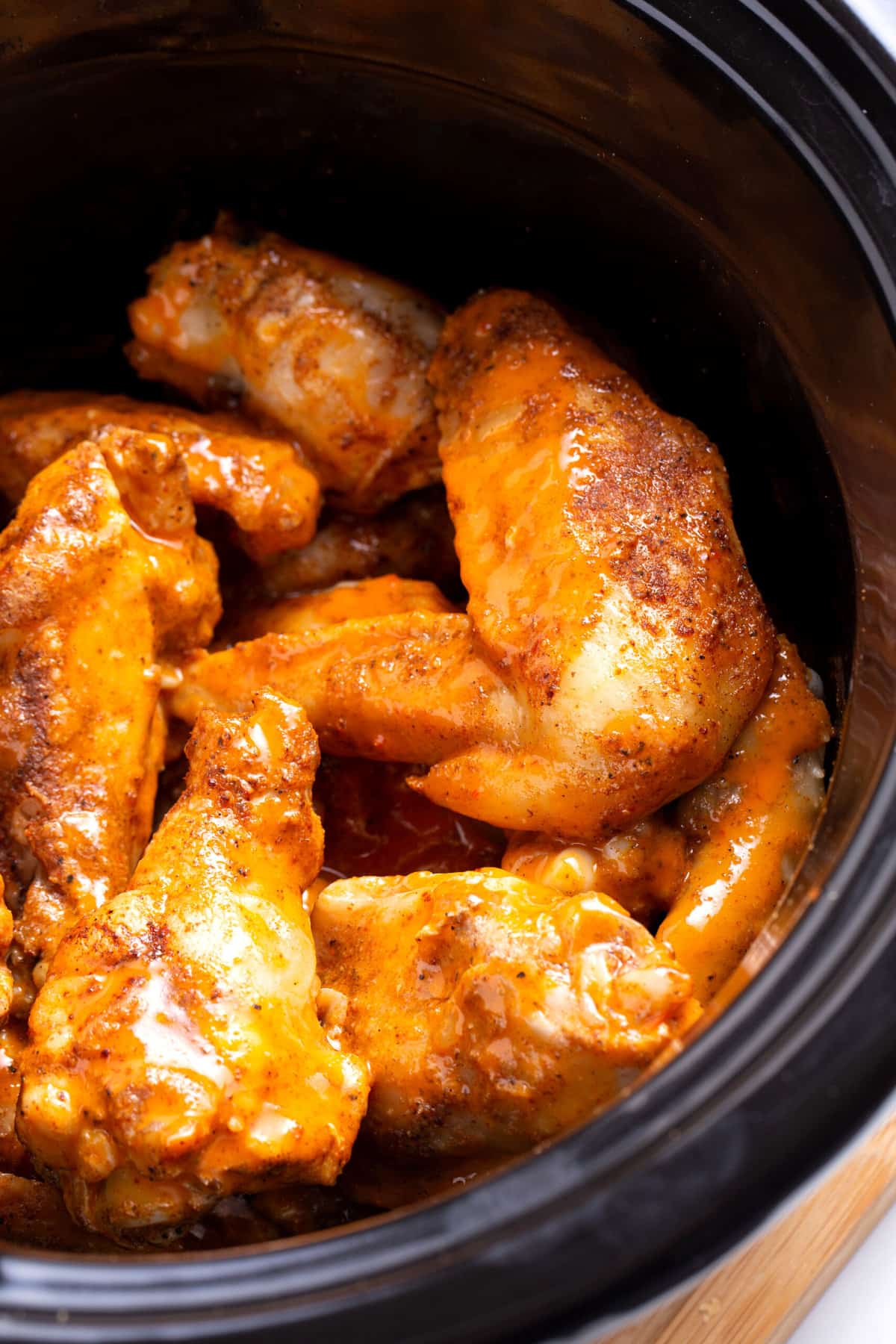 close up image of buffalo chicken wings cooked in a crockpot